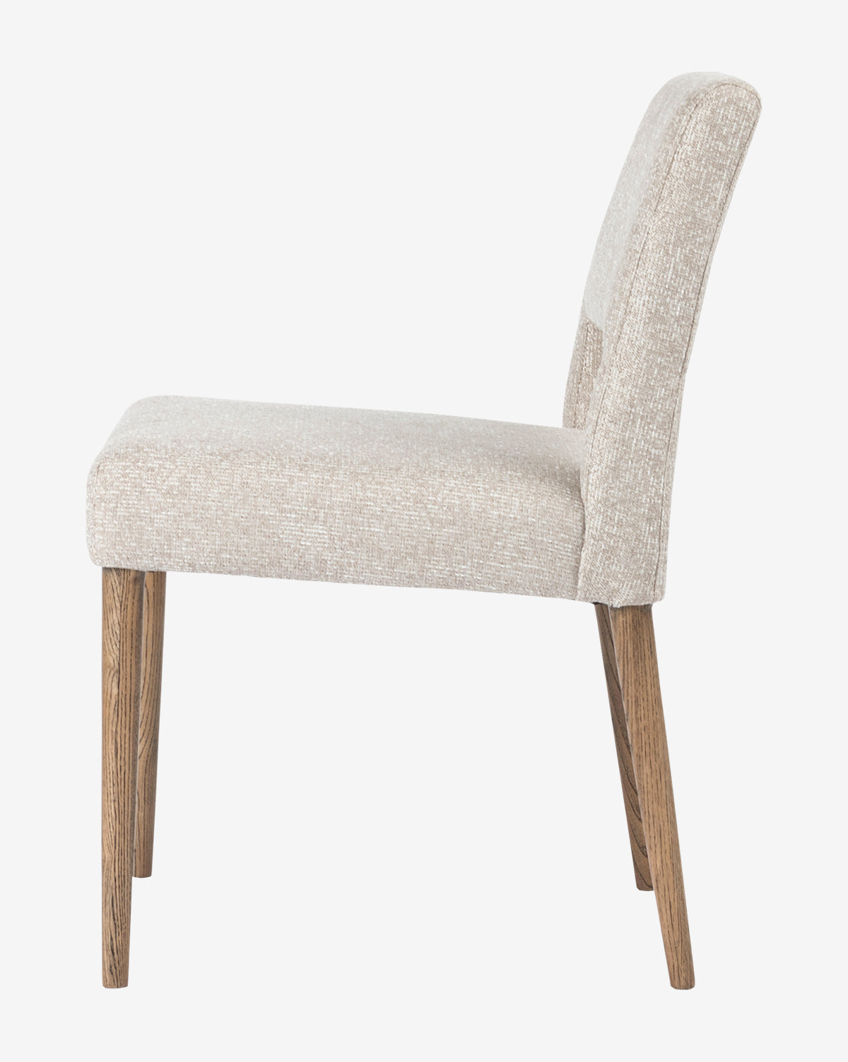 Side view of the Kiernan Dining Chair, featuring a modern design with a beige upholstered seat and backrest, supported by four angled wooden legs, shown against a plain white background, by McGee & Co.