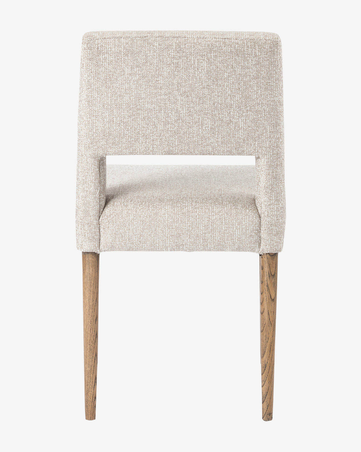 The Kiernan Dining Chair features textured light beige fabric, a straight backrest, and two visible wooden legs, shown from the back against a plain white background by McGee & Co.