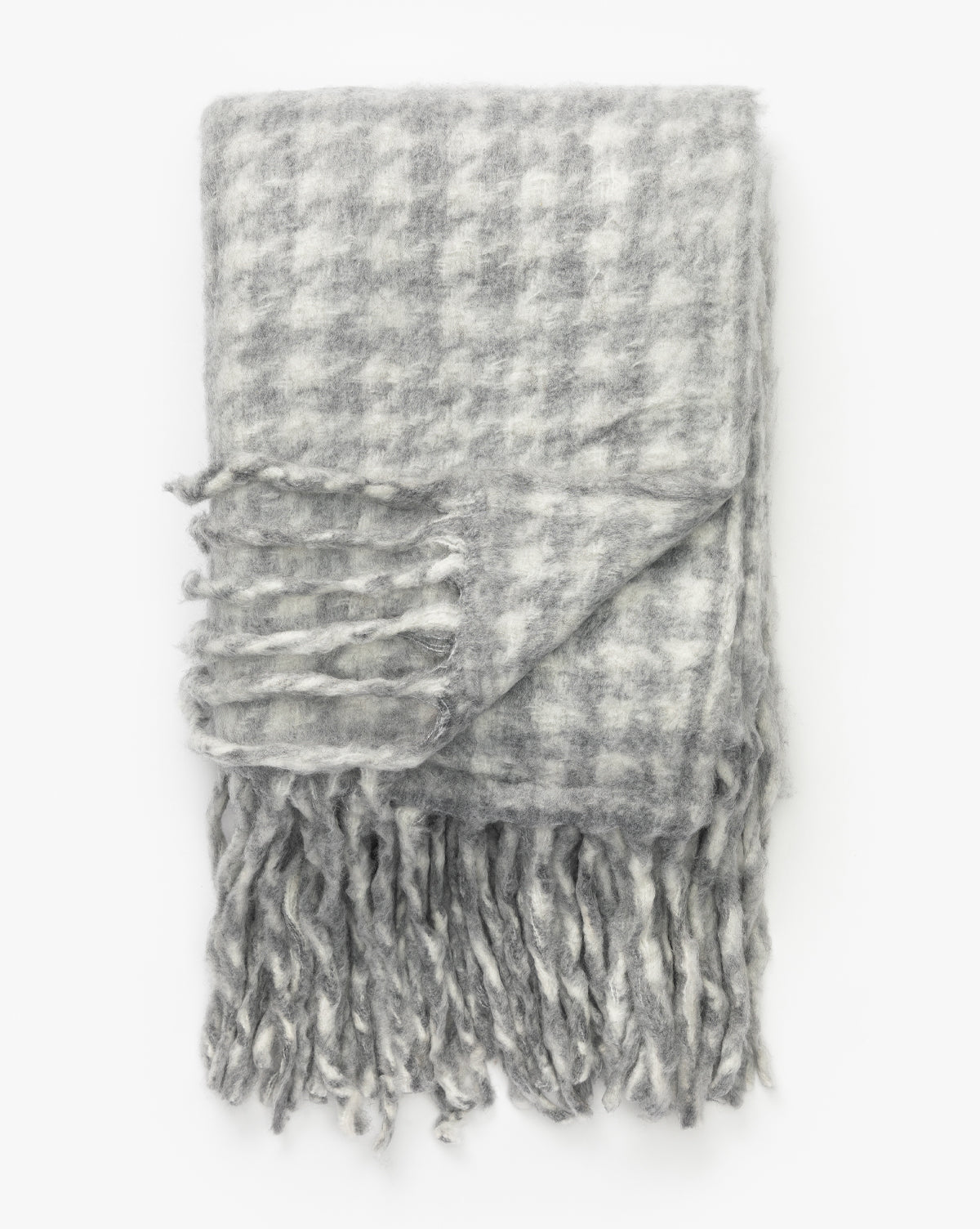 The Indaba Kirsley Houndstooth Throw in gray and white, with fringed ends, adds a touch of luxury to any space—perfect decor for your home. McGee & Co.