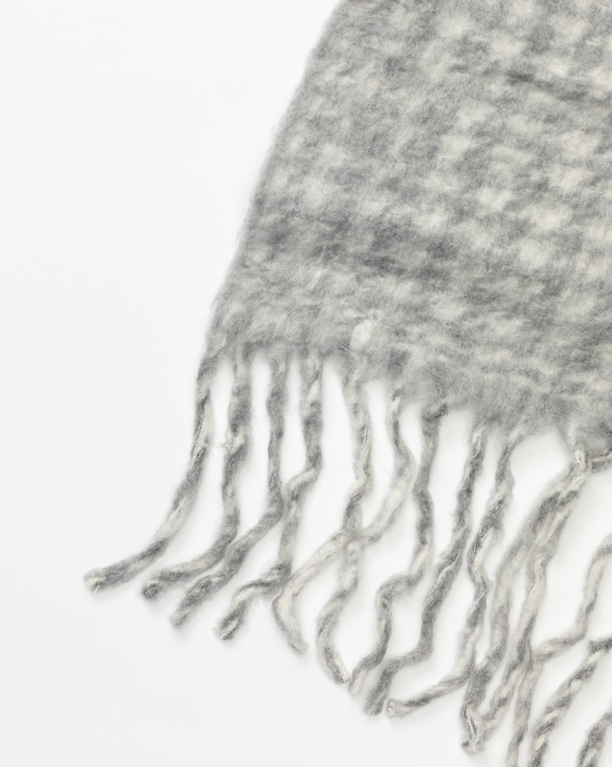 The Indaba Kirsley Houndstooth Throw features a soft wool-blend in gray and white houndstooth with long, twisted fringe, shown close-up against a white background. McGee & Co.