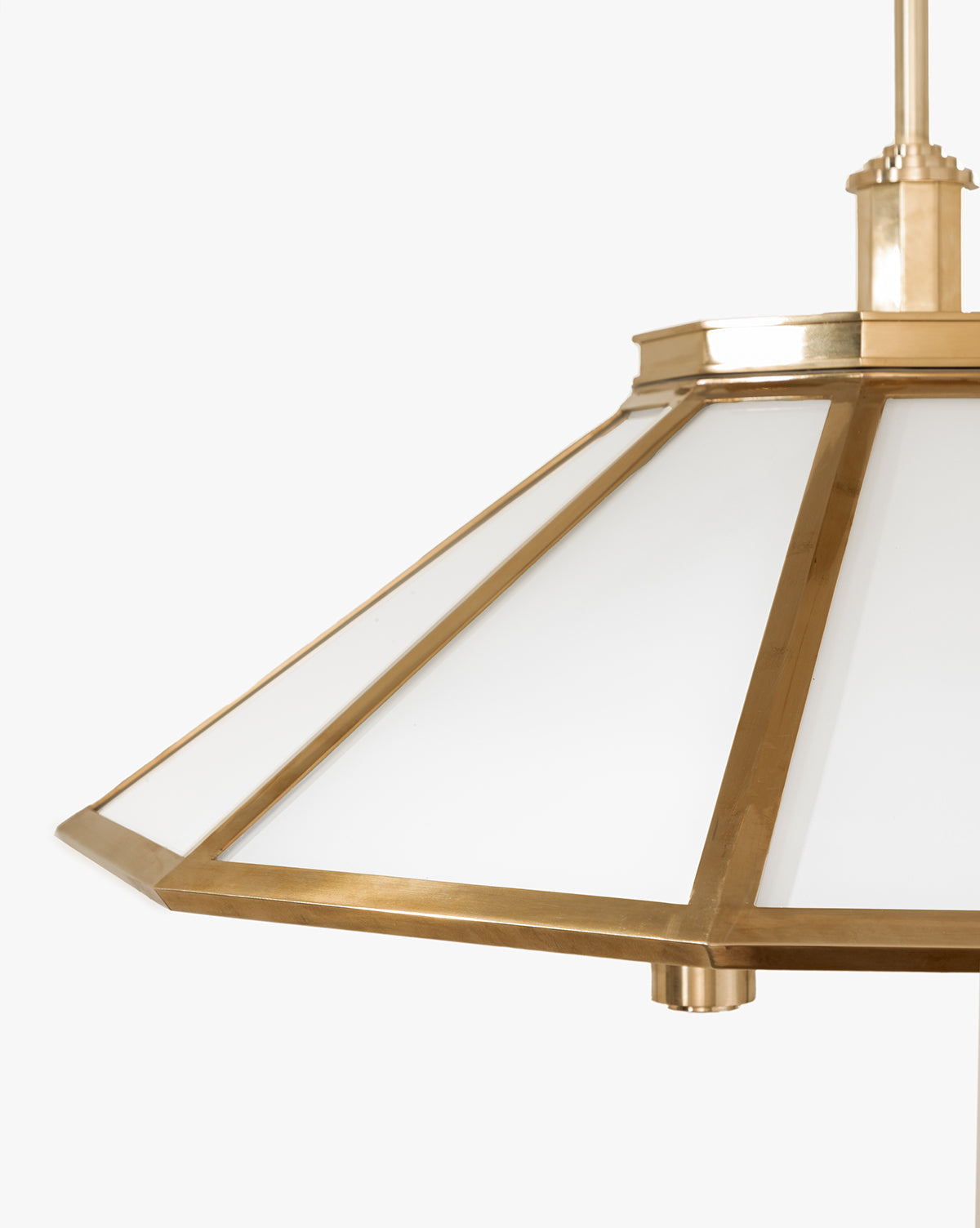 A close-up of the Knightley Chandelier, featuring an antique brass frame and frosted glass panels in a modern geometric design, set against a plain white background, by McGee & Co.