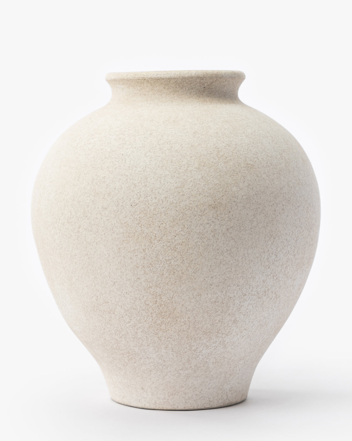 The Krissan Vase is large and round with a smooth, pebbled matte white finish, a slightly narrow neck, and a wide body, shown against a plain white background, by McGee & Co.