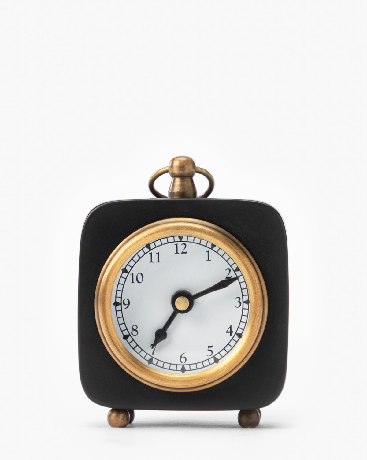 The Kya Clock is a small black accent clock with gold accents and round feet, displaying 8:14 on a plain white background—a stylish addition to any nightstand, by McGee & Co.