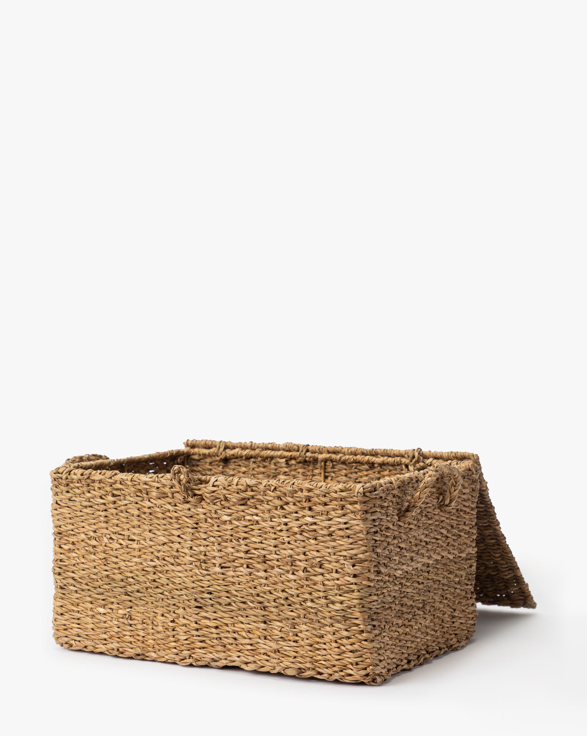 The Kya Seagrass Box is a rectangular, hand-woven basket made from natural fibers with an open lid, displayed on a plain white background—perfect for stylish decorative storage or as a chic seagrass box by McGee & Co.