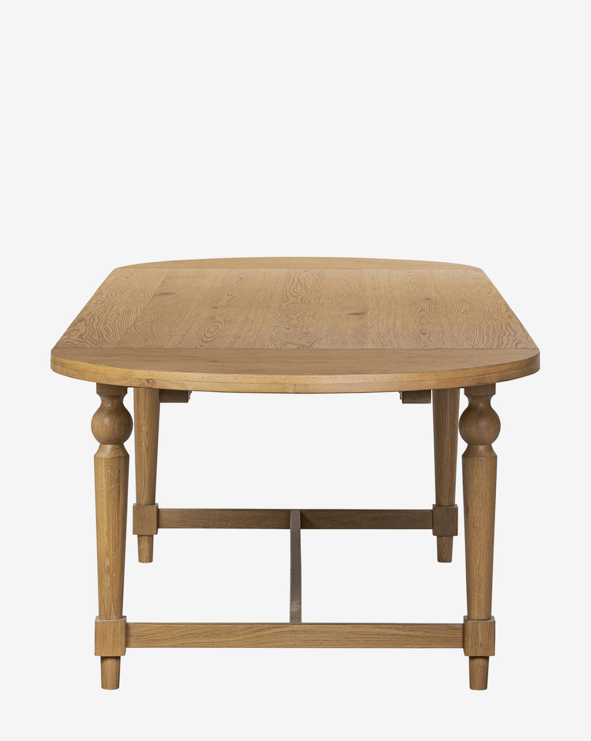 The Kyler Oak Extension Dining Table features a Scandinavian modern design with a wooden rectangular top, rounded corners, and carved legs, displayed front-facing against a plain white background by McGee & Co.