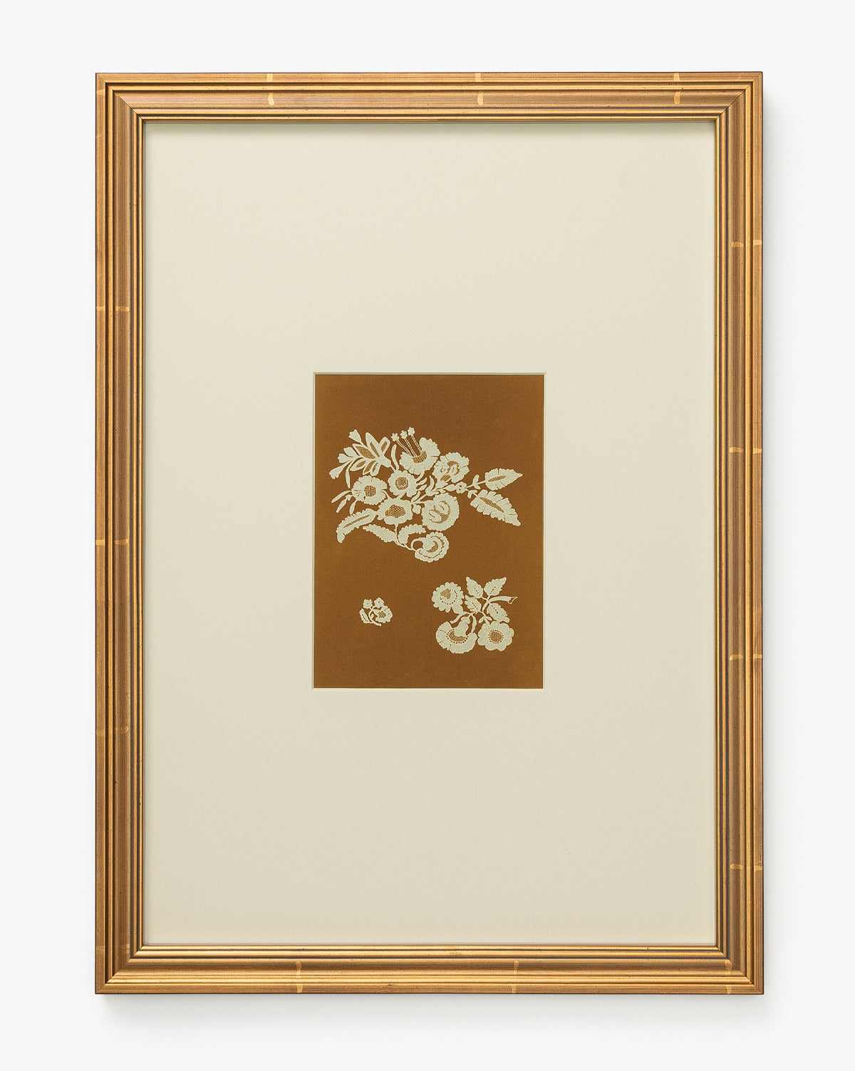 Add elegance to your home with Lace Detail, a gold-framed wall art featuring white lace floral motifs on a brown background, centered within a wide cream mat—an ideal piece for stylish and sophisticated decor, by McGee & Co.