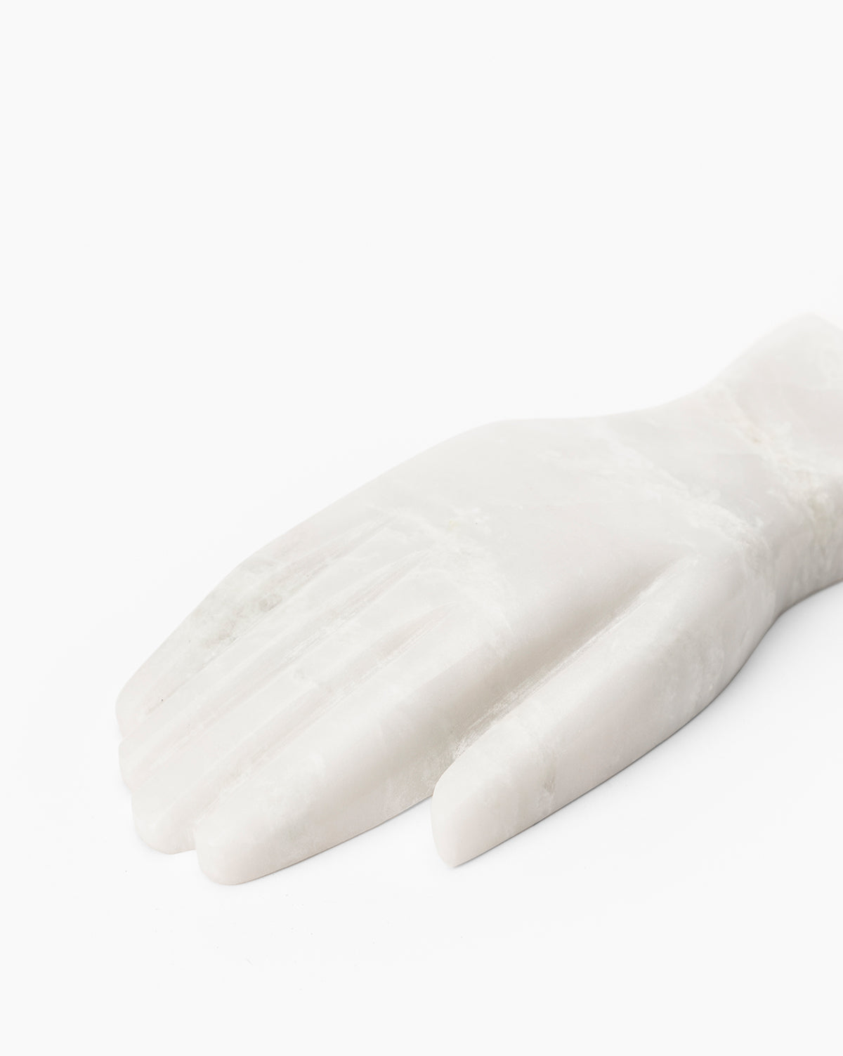 The Lady Onyx Hand Object, crafted from smooth white marble with subtle veining, lies flat against a plain white background. Its minimalist design makes it an ideal decorative piece for contemporary spaces.