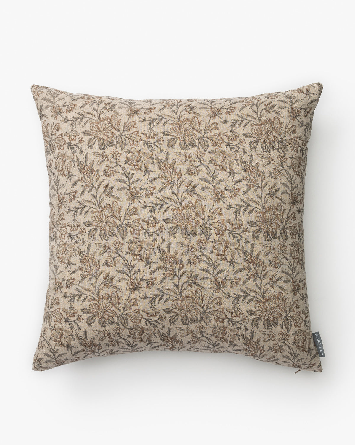 The Lafayette Pillow Cover is a square linen cover with a beige background, detailed brown floral pattern, small side fabric tag, and a classic vintage-inspired design by McGee & Co.