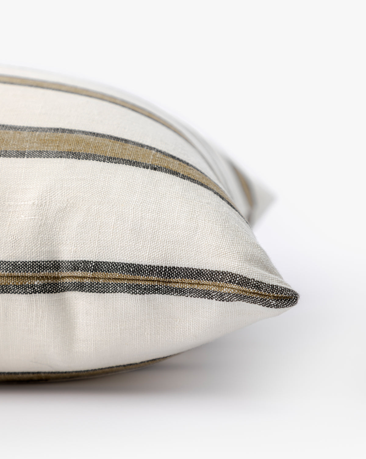 Close-up of the Lago Pillow Cover, featuring cream color with horizontal black and tan stripes. Set against a white background, its soft texture makes it ideal for adding a touch of cozy style to your space, by McGee & Co.