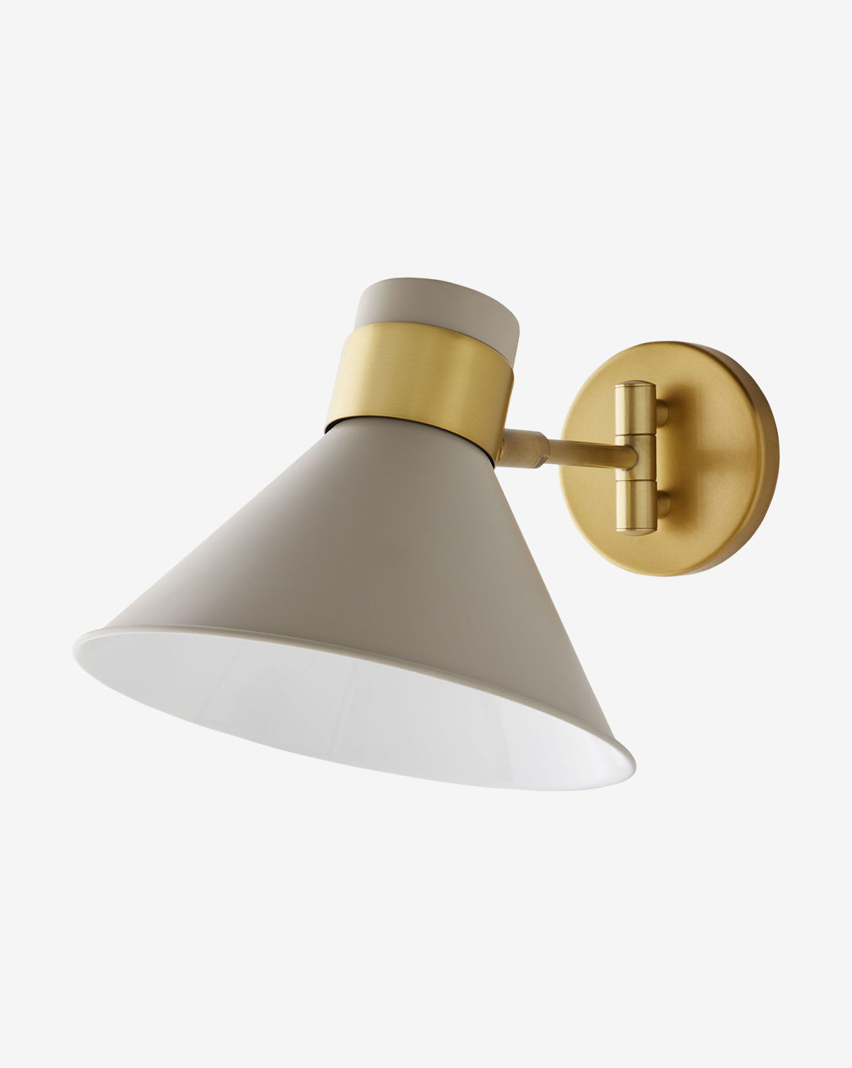 The Arteriors Lane Sconce features a matte white conical shade, antique brass accents, and a round gold wall plate, providing adjustable lighting for personalized illumination. McGee & Co.