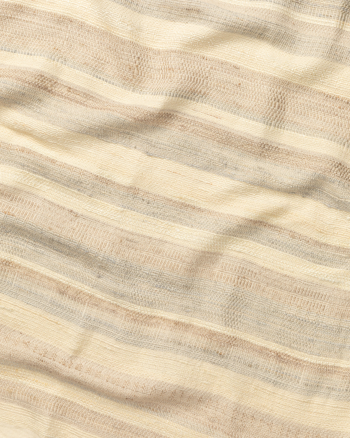 The Laney Stripe Throw by TAL HANDWOVEN CLASSICS LLP features beige and cream woven fabric with subtle horizontal stripes and a textured finish—ideal for adding elegance and warmth to any space. McGee & Co.