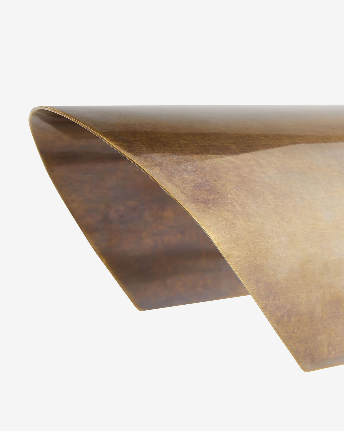 A close-up of the Lansing Table Lamps curved, thin metallic sheet in a bronze finish, evoking vintage brass, set against a plain white background, by McGee & Co.