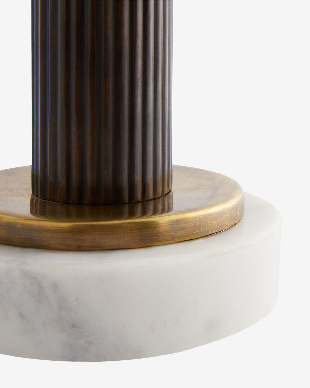 Close-up of the Lansing Table Lamp, showcasing its ribbed dark metal column, vintage brass accents, and eye-catching circular white marble base, by McGee & Co.