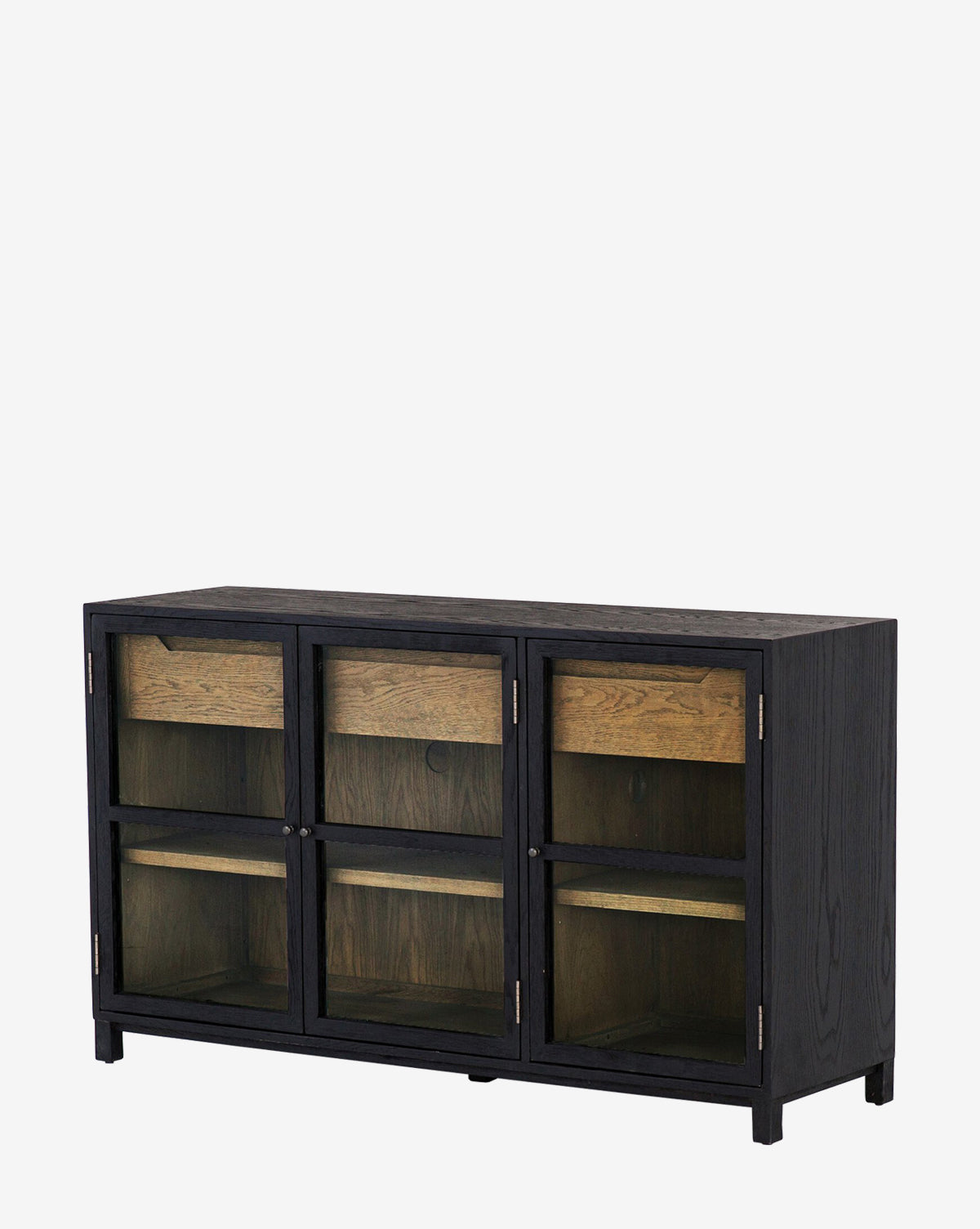 The Laura Sideboard is a black oak cabinet with three sections, each with glass doors and an interior shelf. It features a simple, modern design and natural wood accents inside.