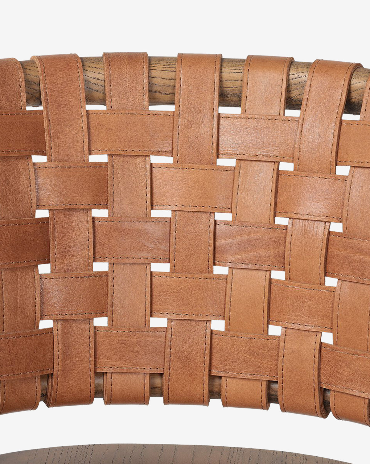 Close-up of the Lennon Dining Chair’s backrest, with tan leather straps woven over a wooden frame, by McGee & Co.