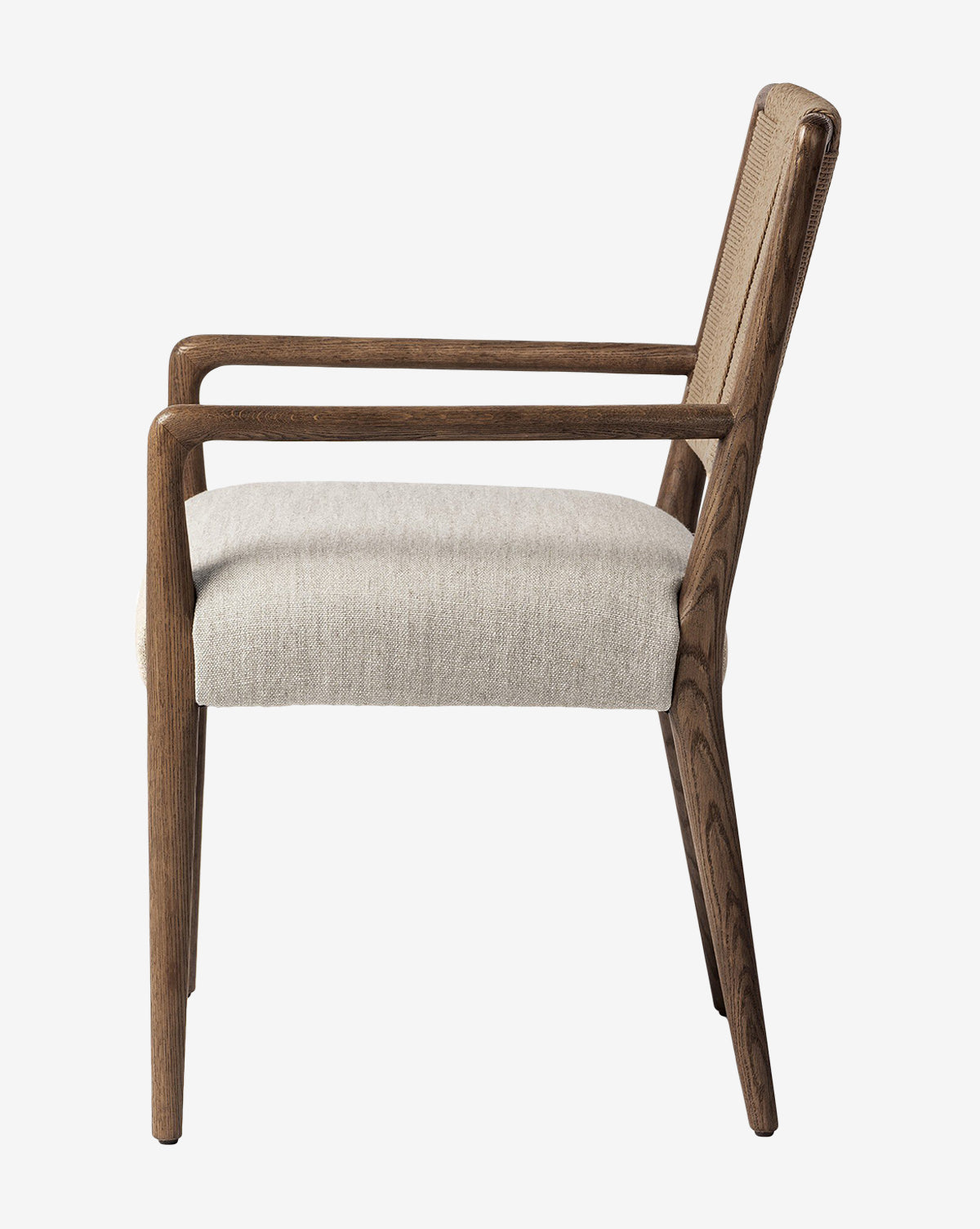 Side view of the Leola Dining Armchair, featuring a modern oak frame and light beige upholstered seat and backrest. Clean lines and minimalist design showcase the elegance of this wooden armchair, by McGee & Co.