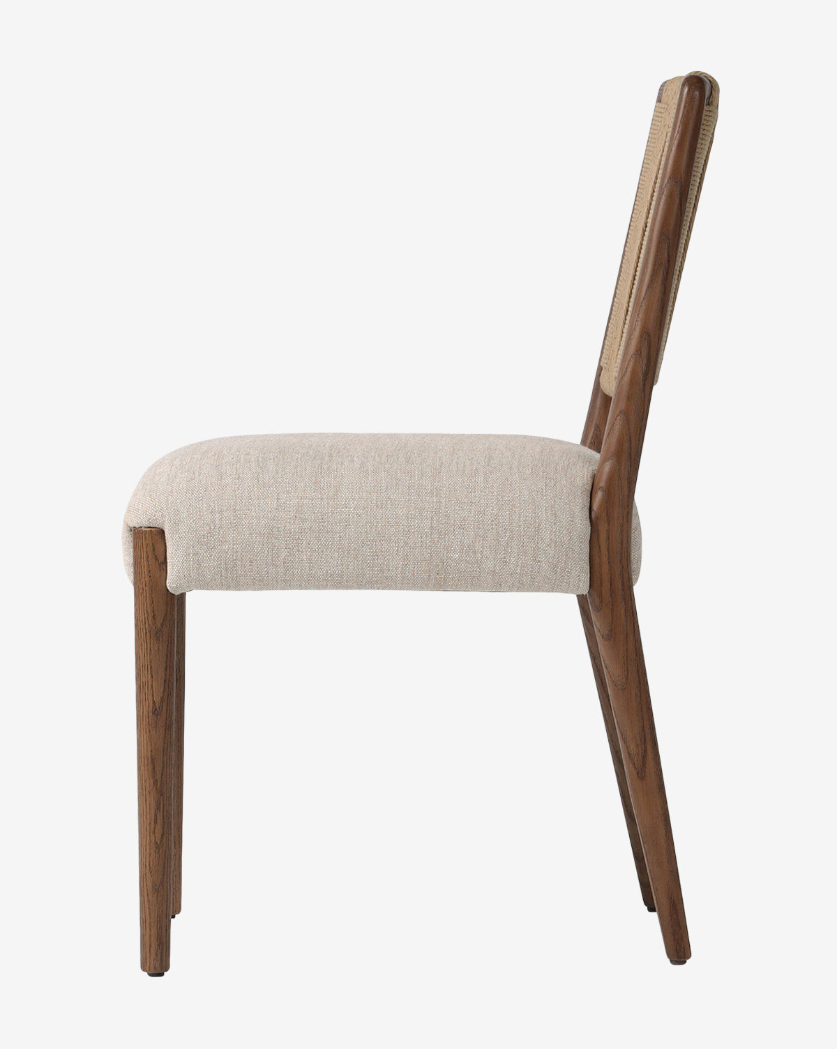 Side view of the Leola Dining Chair featuring a modern oak frame, angled wooden legs, and a light beige upholstered seat and backrest, photographed against a plain white background by McGee & Co.