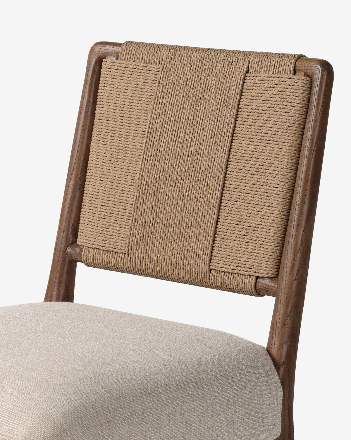 A close-up of the Leola Dining Chair showcases its oak frame, rush seat back, and light beige upholstered seat, all set against a plain white background, by McGee & Co.