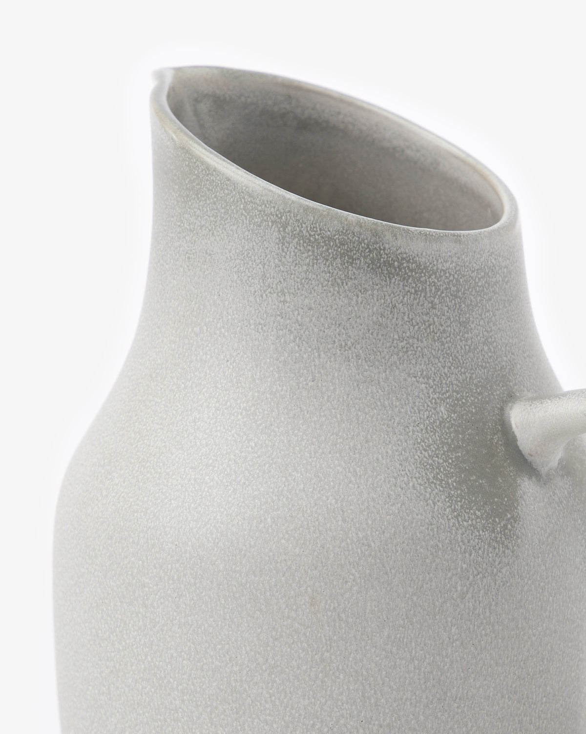 A close-up of the Levi Stoneware Pitcher, featuring a matte light grey finish, wide slanted spout, and small curved handle, set against a plain white background by McGee & Co.