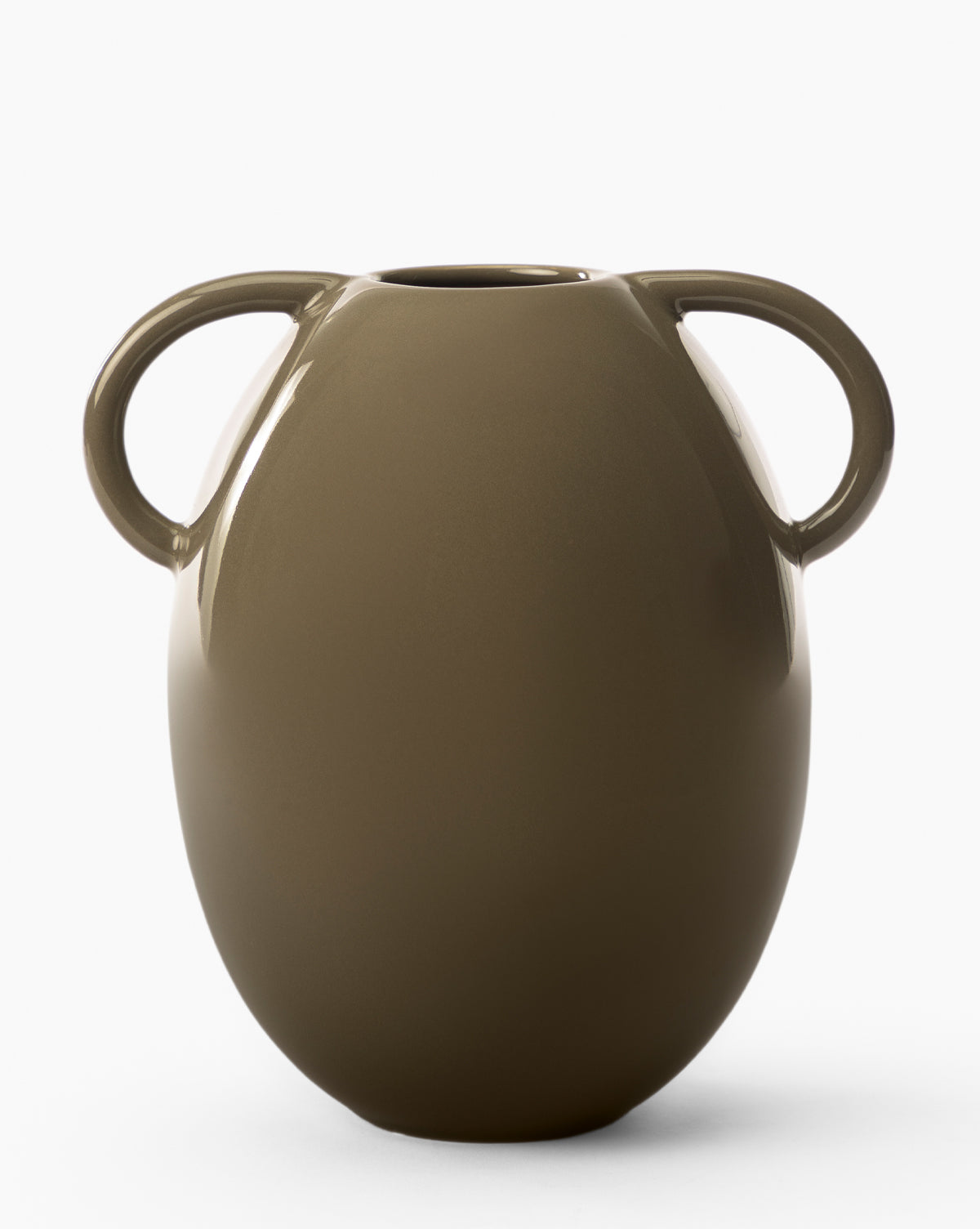 The Leylani Vase is a smooth, brown ceramic vase with a rounded body and two large curved handles, creating a striking decorative accent against a plain white background.