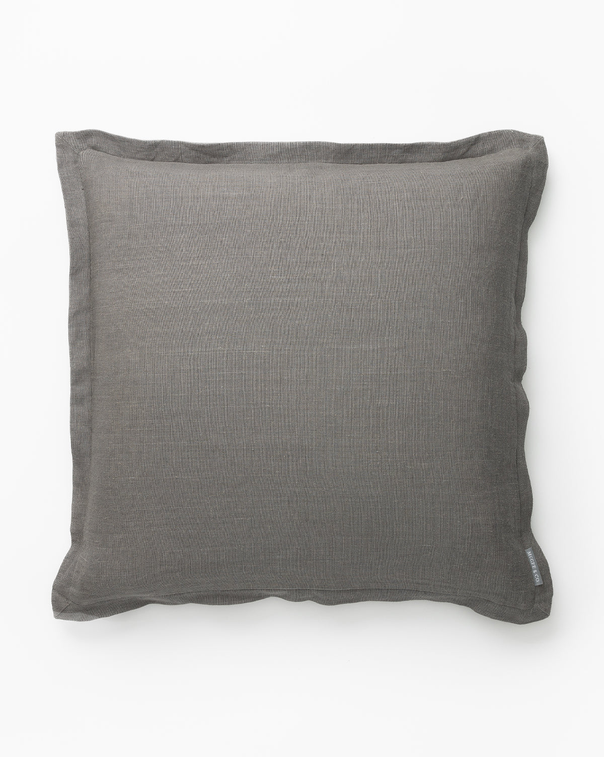 The Liam Double Flange Pillow Cover is a square, dark gray decorative pillow cover with a subtle linen texture and double flange detail, shown from above on a plain white background by McGee & Co.