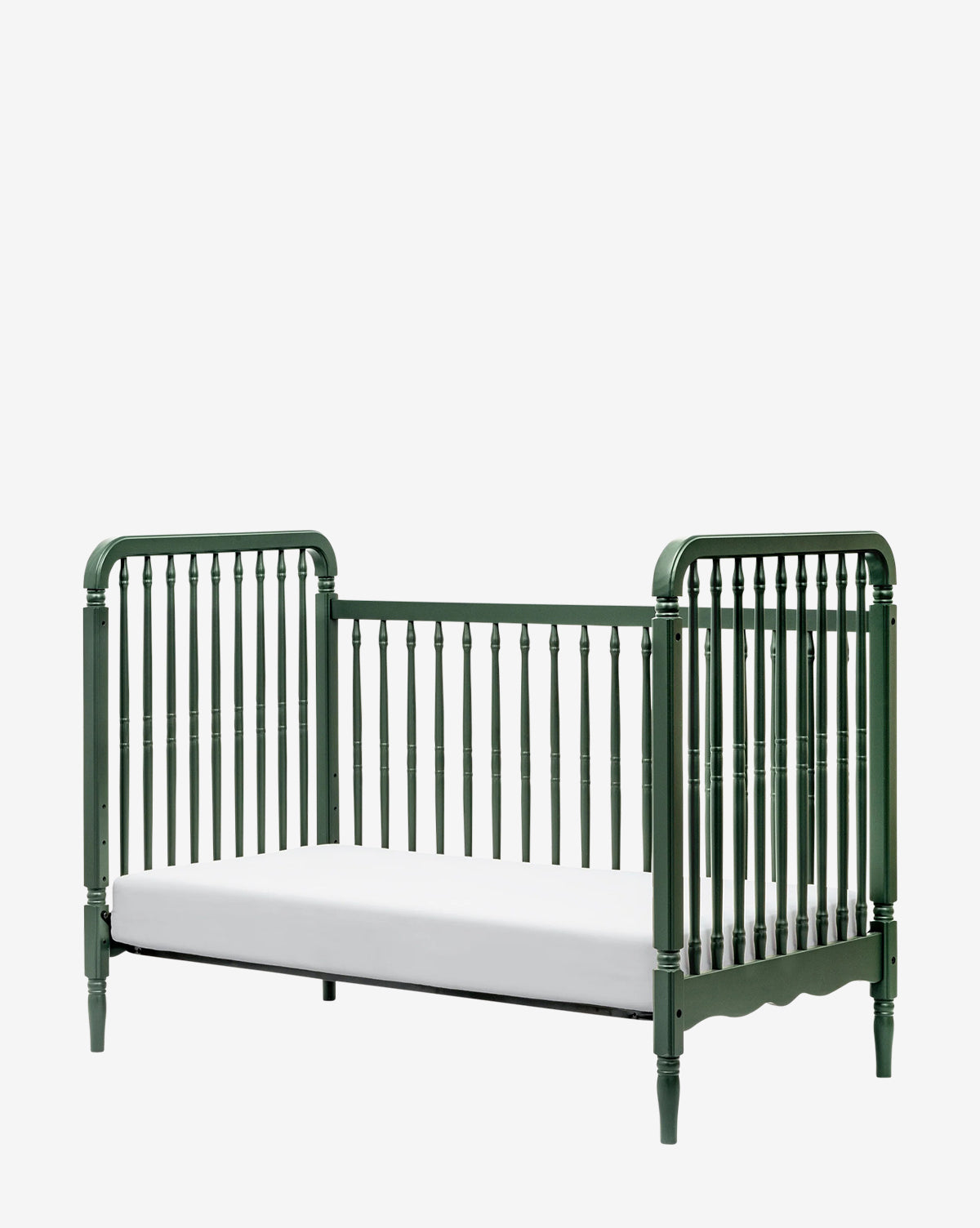 The Liberty 3-in-1 Convertible Spindle Crib with Toddler Bed Conversion Kit offers a stylish green wooden toddler bed with vertical slats, curved headboard and footboard, and turned legs for an easy crib-to-bed transition, by McGee & Co.