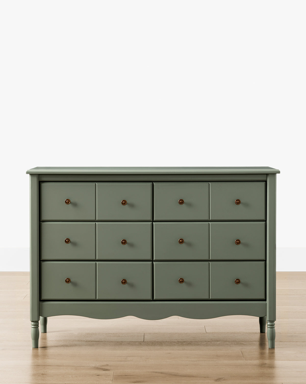 The Liberty 6-Drawer Assembled Dresser, in green sustainable pine, features six drawers with round dark knobs and stands on a light wood floor against a plain white background, by McGee & Co.