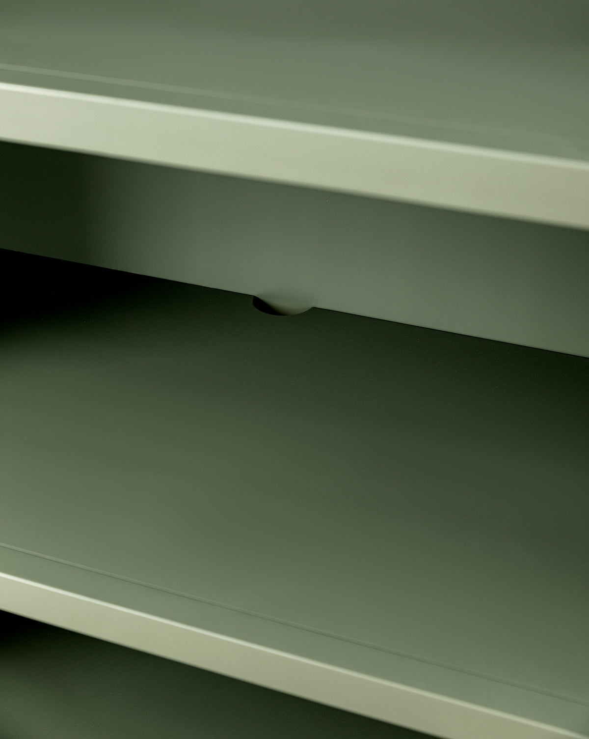 A close-up of the Liberty Bookcase’s empty, greenish-gray metal shelves highlights heirloom craftsmanship with a small notch visible on the edge of the middle shelf, by McGee & Co.