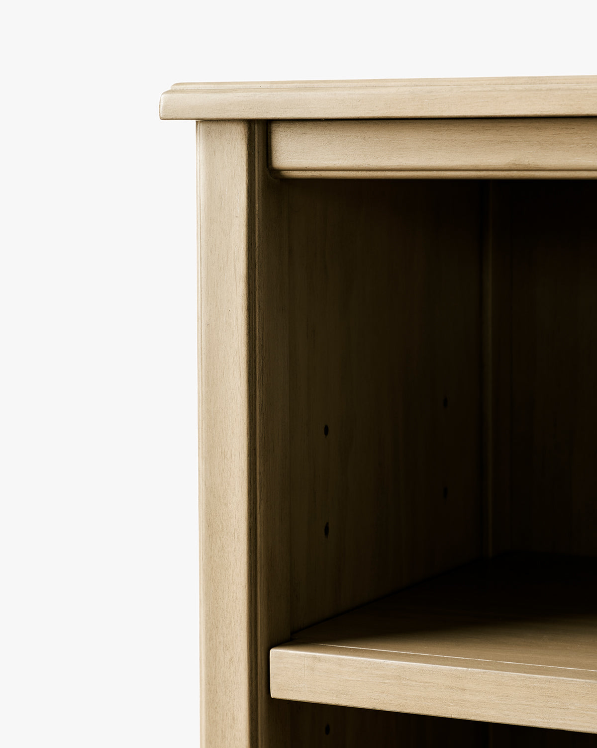 Close-up of the Liberty Bookcase’s top corner and side in a light finish, featuring one shelf and an empty interior, highlighting heirloom craftsmanship against a plain white background, by McGee & Co.