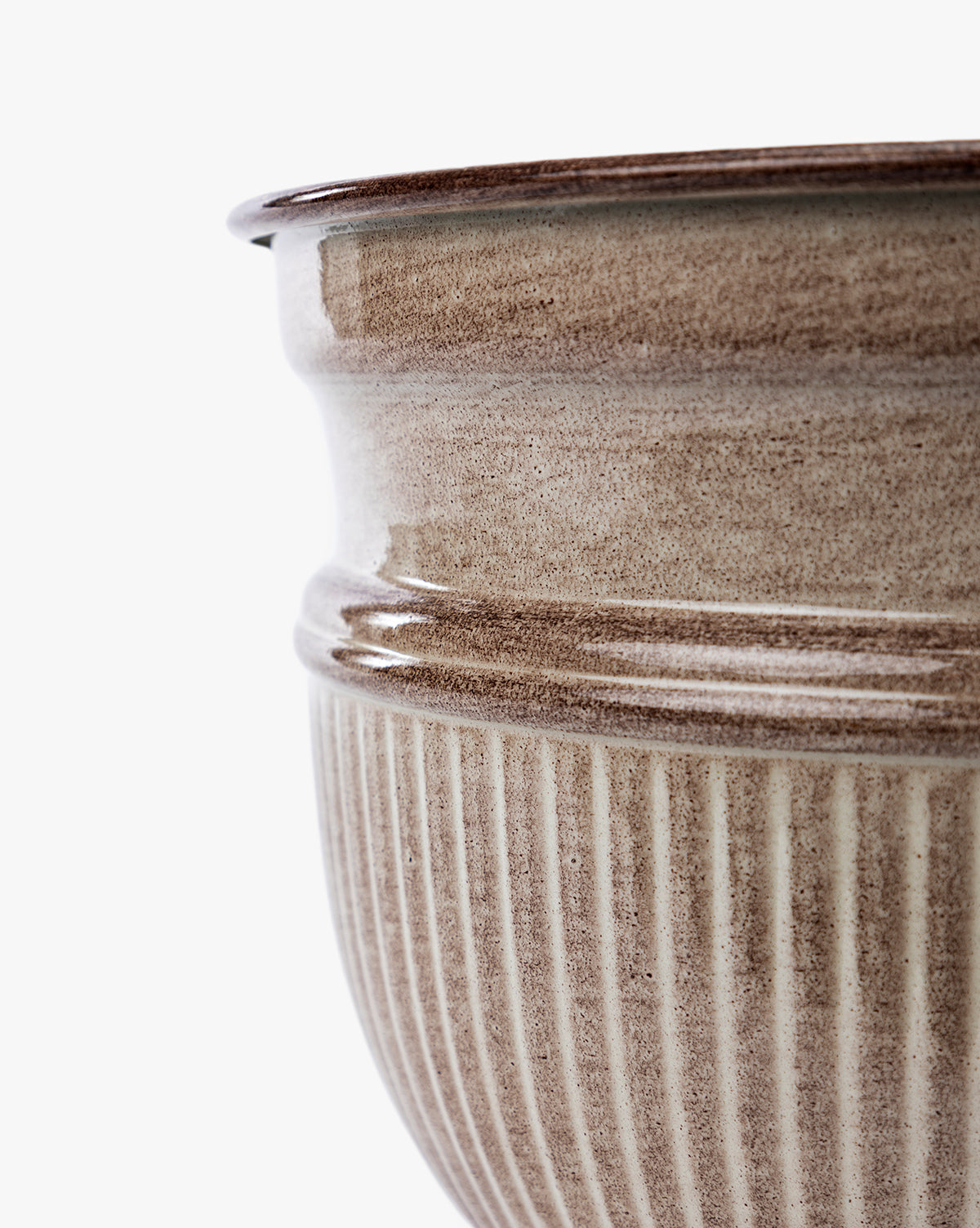 Close-up of the upper portion of a ribbed, light brown Lichfield Planters ceramic pot (Set of 3) with a glossy finish, highlighting detailed texture and curvature—ideal as stylish, weather-resistant outdoor planters by McGee & Co.