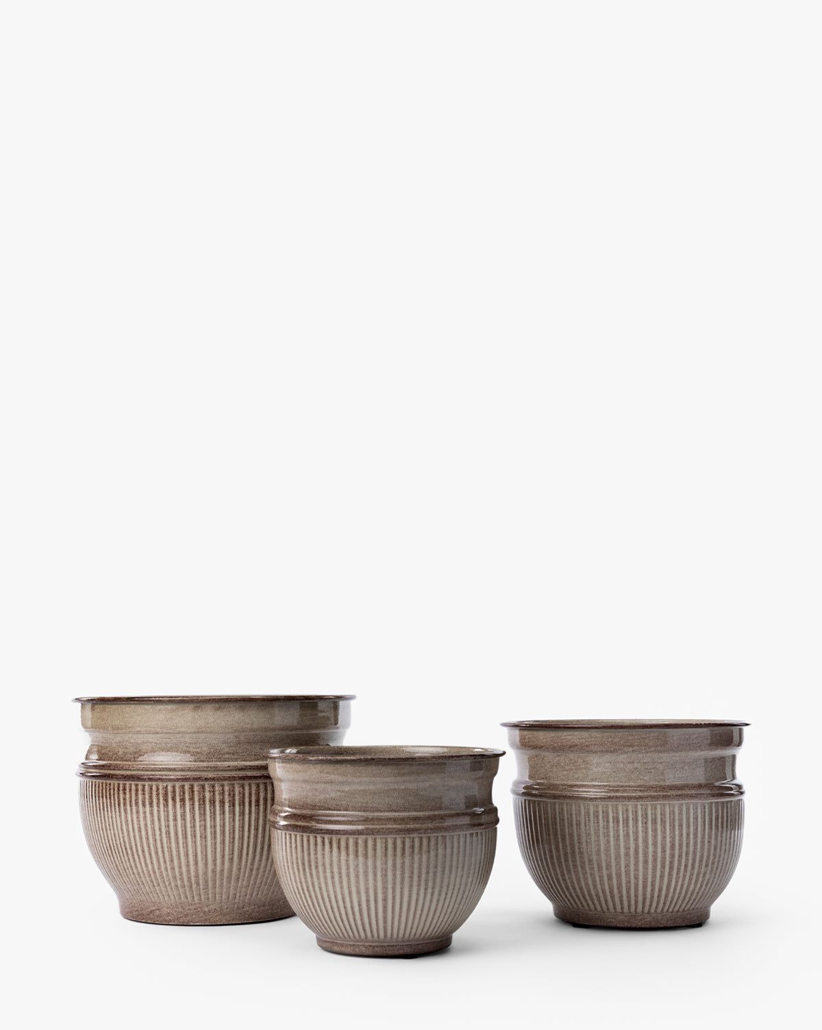The Lichfield Planters (Set of 3) by Napa Home & Garden feature round ceramic designs with ribbed texture and taupe glaze—stylish, weather-resistant options for outdoor spaces, shown on a plain white background. McGee & Co.