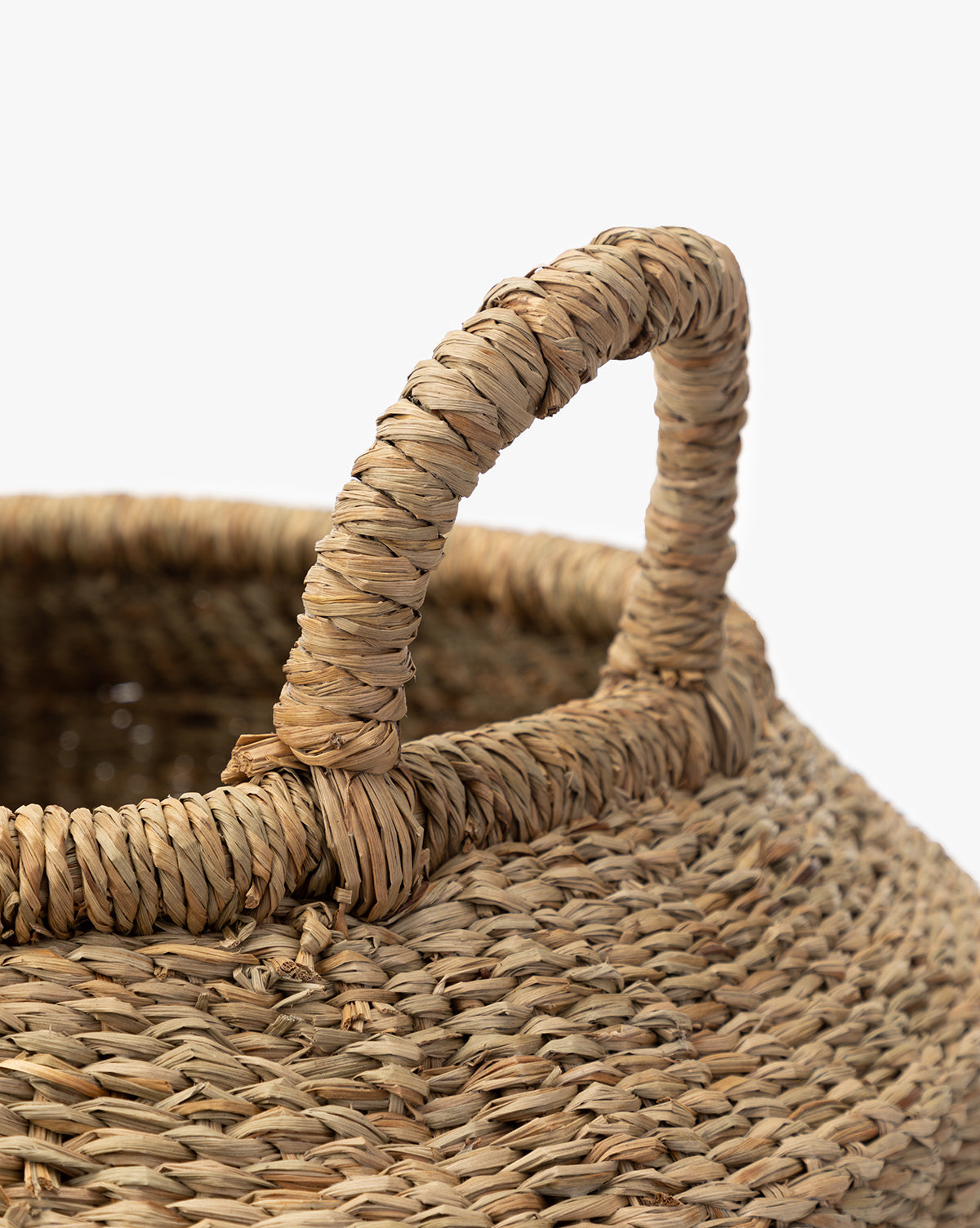 Close-up of the Liesl Basket, featuring intricate woven mendong grass and a sturdy upright handle, set against a plain white background, by McGee & Co.