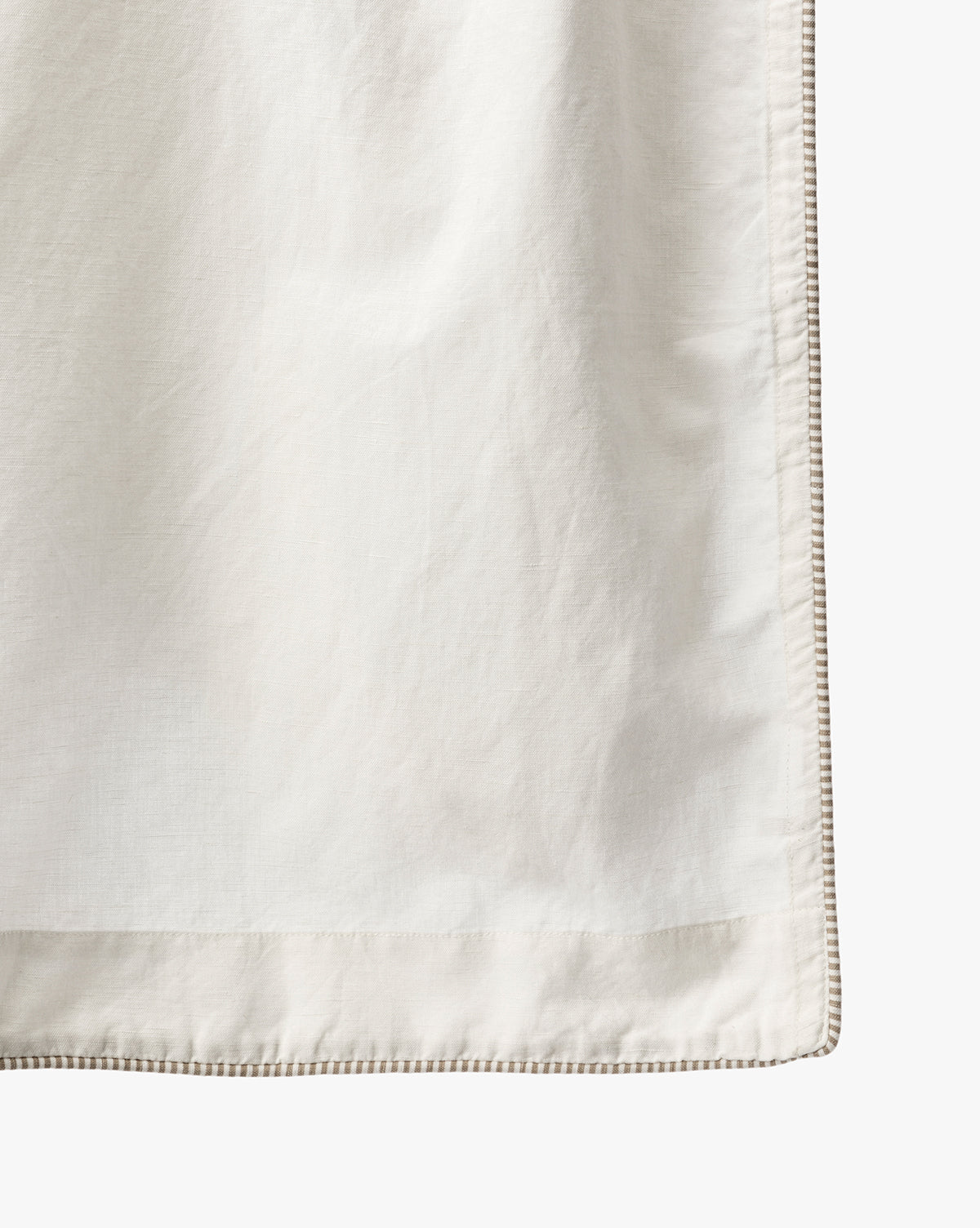 A close-up of the Lillian Shower Curtain with Striped Ties shows its light-colored linen fabric, smooth texture, and refined striped border, bringing an elegant touch to any bathroom décor, by McGee & Co.