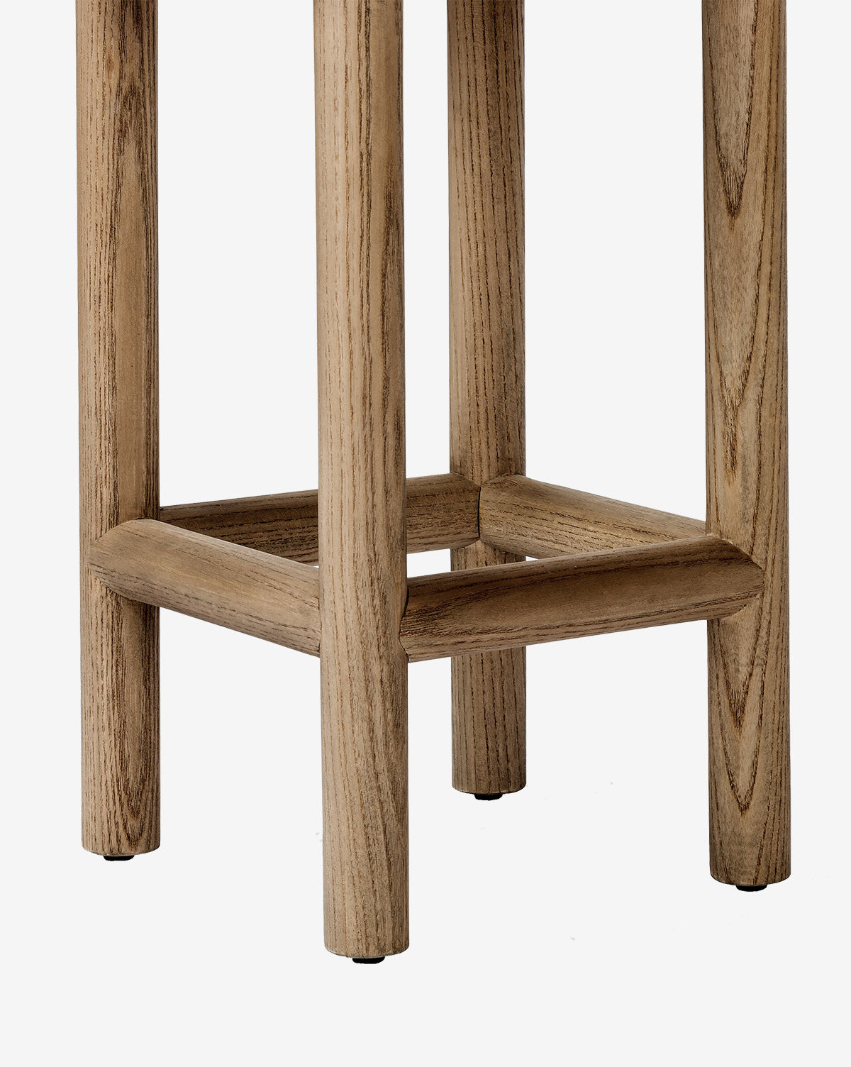 Close-up of the lower section of the Linus Stool, perfect for counters. This stool showcases four legs linked by a square support frame and offers a natural light wood finish with visible grain patterns by McGee & Co.