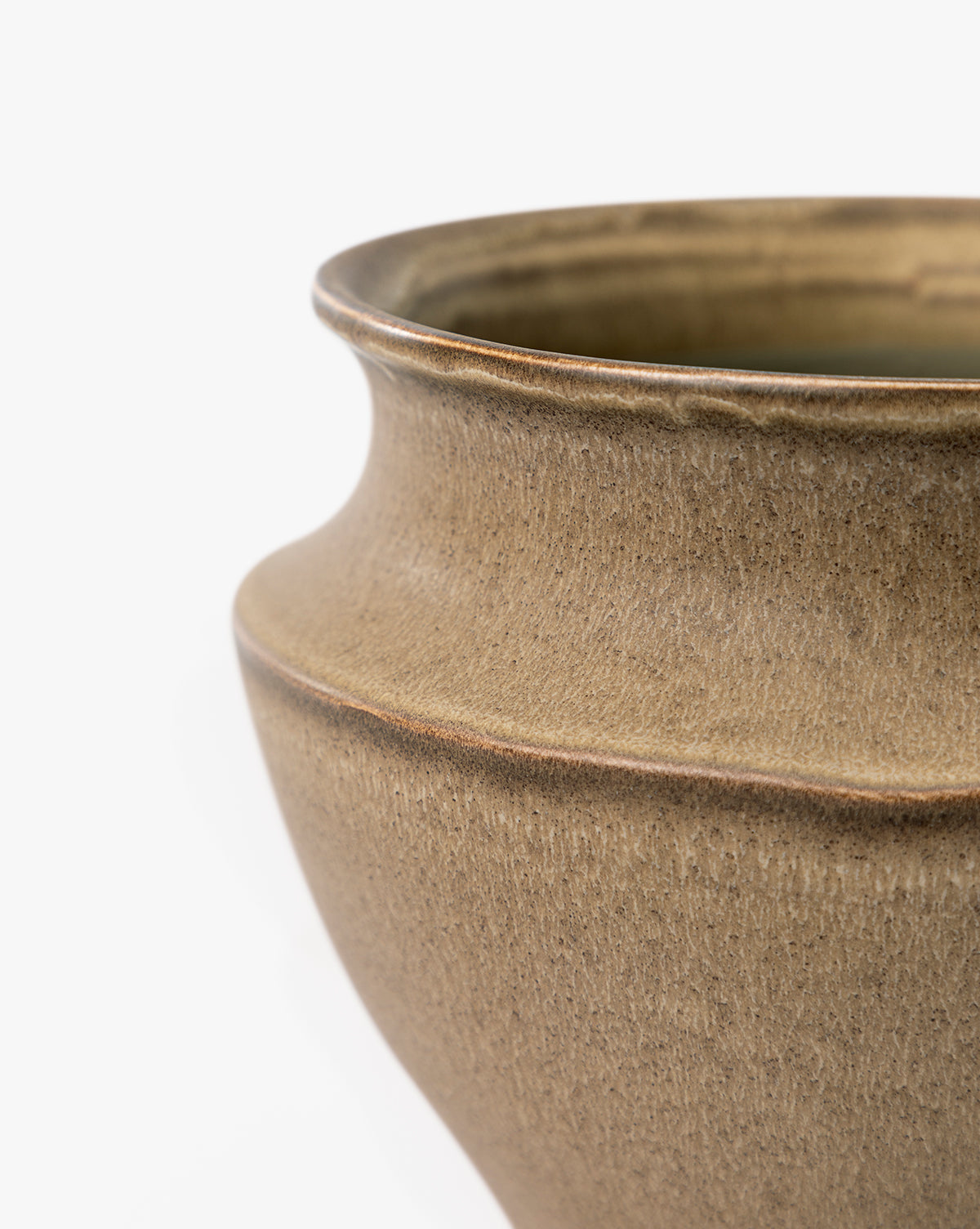 Close-up of the upper part of the brown Liora Pot ceramic vase, featuring a wide, rounded rim and smooth textured surface, set against a white background, by McGee & Co.