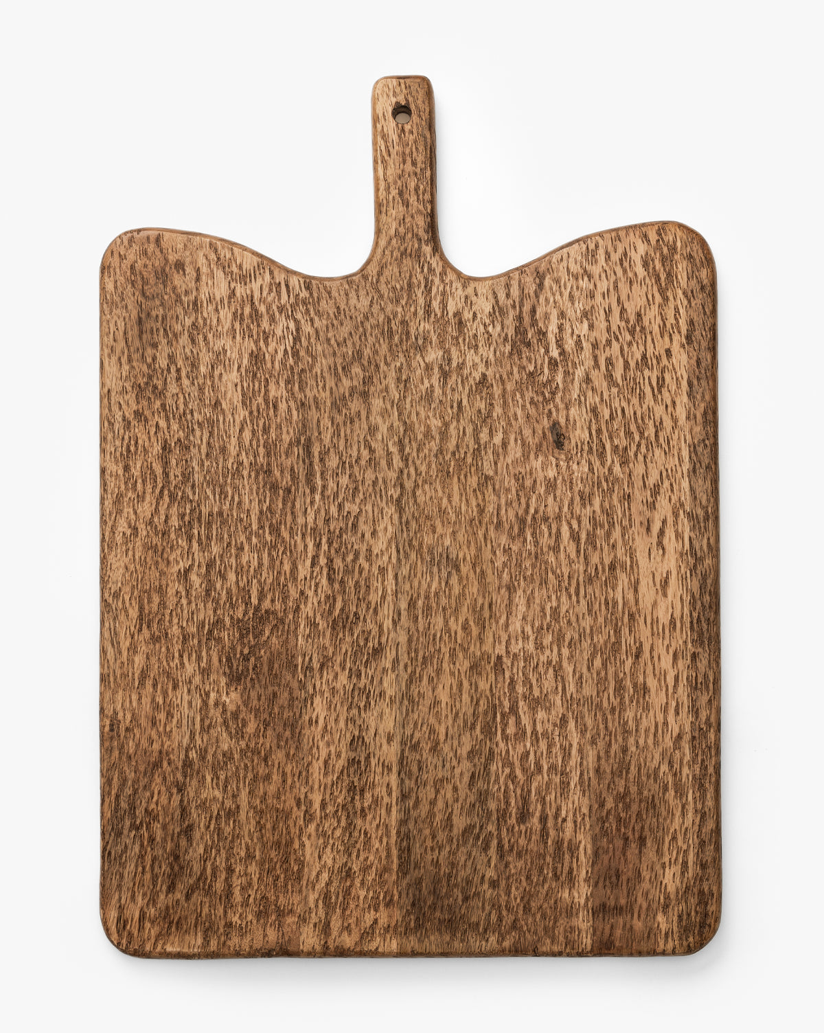 The Longfellow Breadboard is a rectangular mango wood board with a rounded handle and small hanging hole, ideal for serving or as stylish kitchen decor, shown on a white background by McGee & Co.