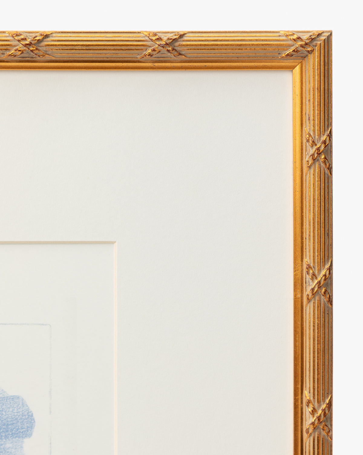 Close-up of the top right corner of a gold frame with a textured, crisscross pattern and white mat, partially revealing the Loose Ribbons light blue giclee print—a cheerful accent ideal for childrens rooms, by McGee & Co.