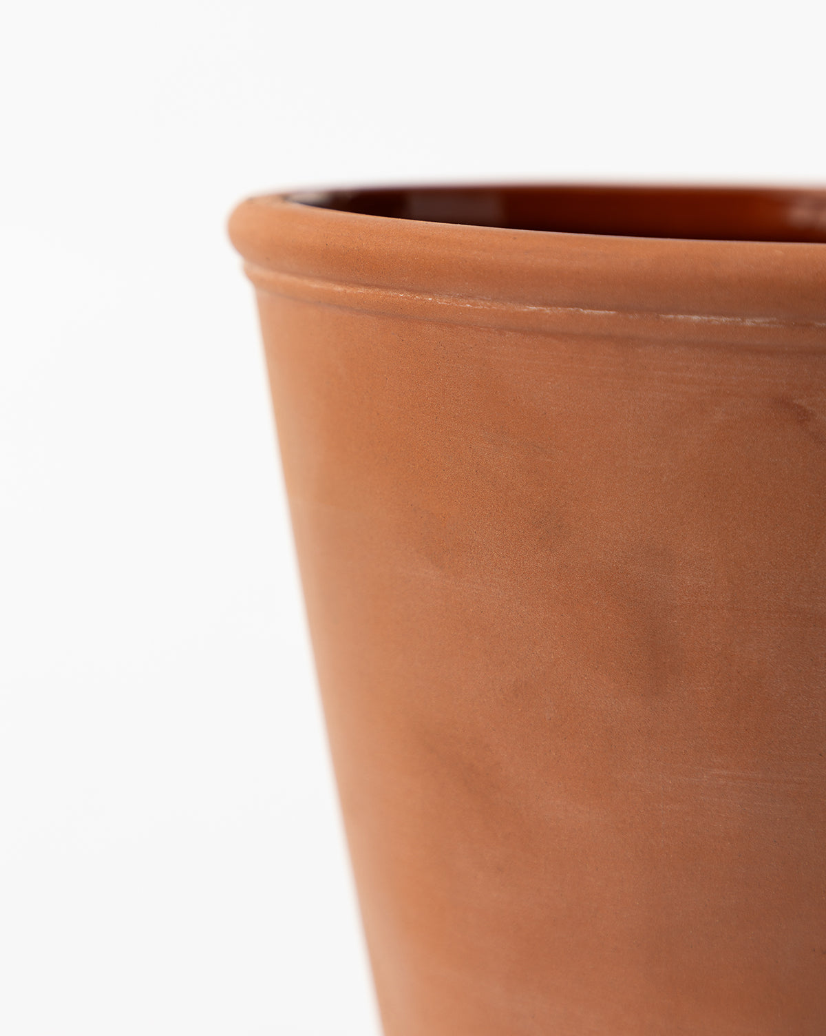 Close-up of the top half of the Lorenzo Terracotta Pot, featuring a smooth texture against a white background—ideal as an indoor or outdoor planter for any space, by McGee & Co.