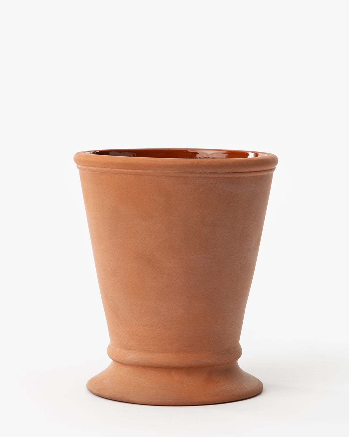 The Lorenzo Terracotta Pot is a simple, unglazed planter with a wide rim and slightly flared base, perfect for indoor or outdoor use. Shown here on a plain white background, by McGee & Co.