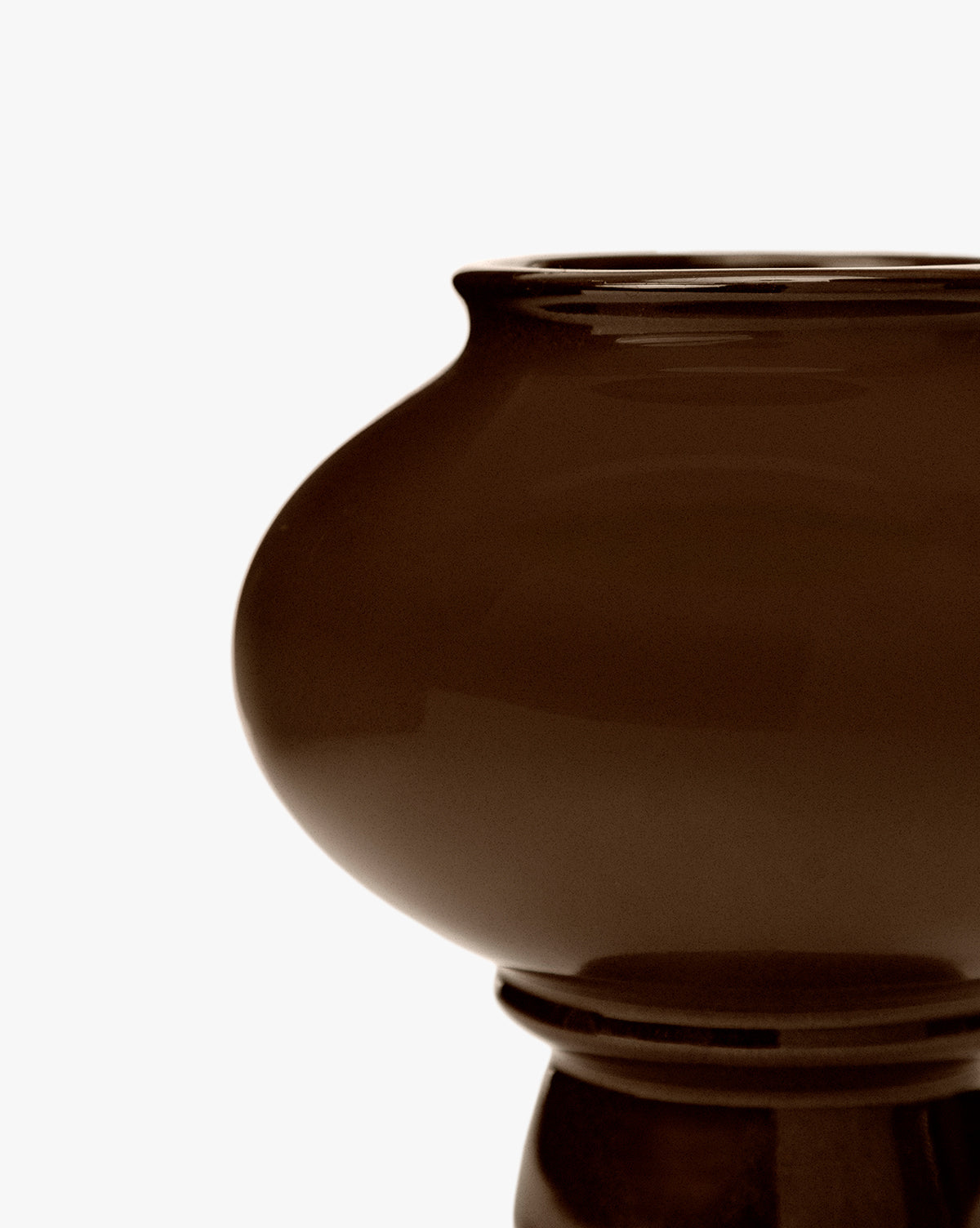 A close-up of the Louis Vase showcases its glossy dark brown ceramic finish, wide rounded body, and sculptural silhouette, all set against a plain white background, by McGee & Co.
