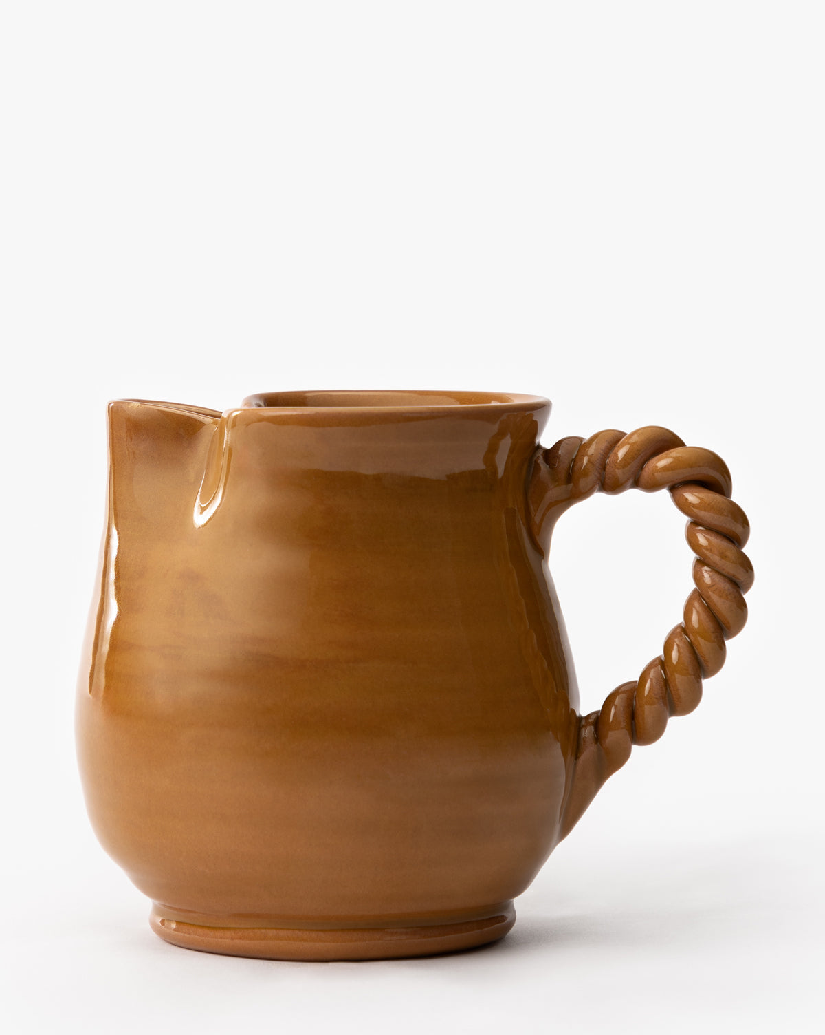 The Louise Jug is a brown terracotta vessel featuring a glossy earthenware glaze and a twisted, rope-style handle, set against a plain white background, by McGee & Co.