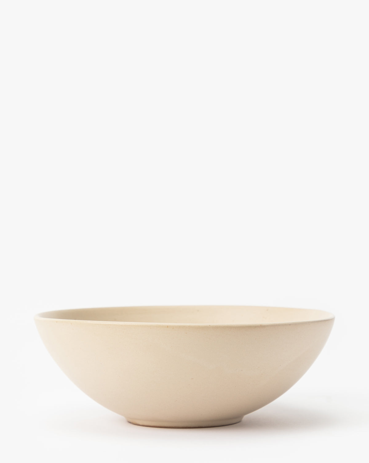 The Luana Bowl is crafted from glazed stoneware in a light beige tone with a smooth finish, displayed on a white background by McGee & Co.