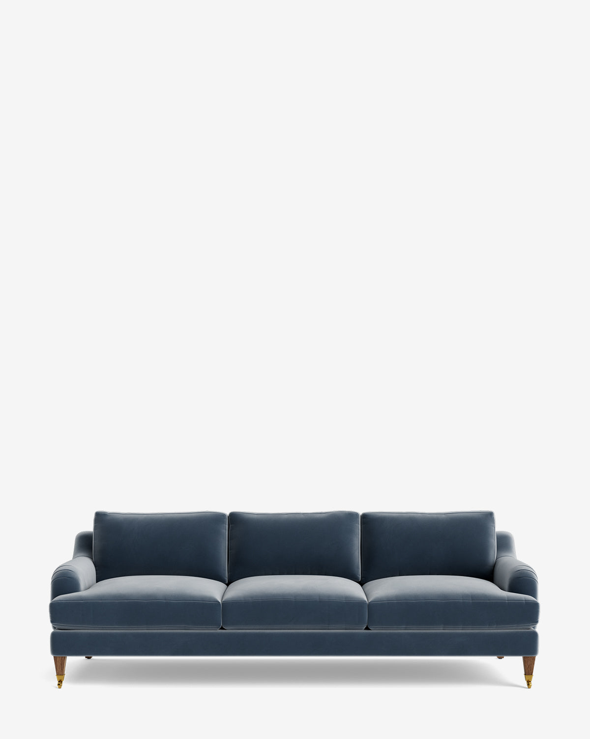 The Lucille English Roll Arm Sofa 90.5 is upholstered in blue velvet, with three down-wrapped cushions and short wooden legs featuring brass rollers, shown against a plain white background by McGee & Co.
