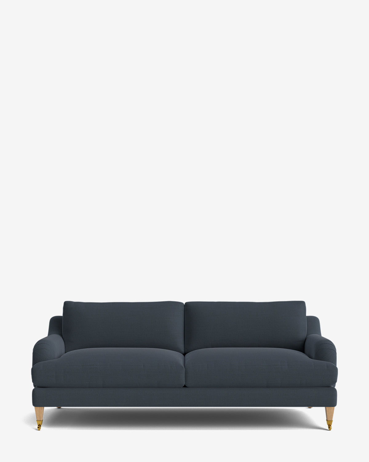 The Lucille English Roll Arm Sofa 78 in dark blue features two plush down-wrapped seat and back cushions, slim armrests, and short light wood legs with gold-colored casters, all shown against a plain white background by McGee & Co.