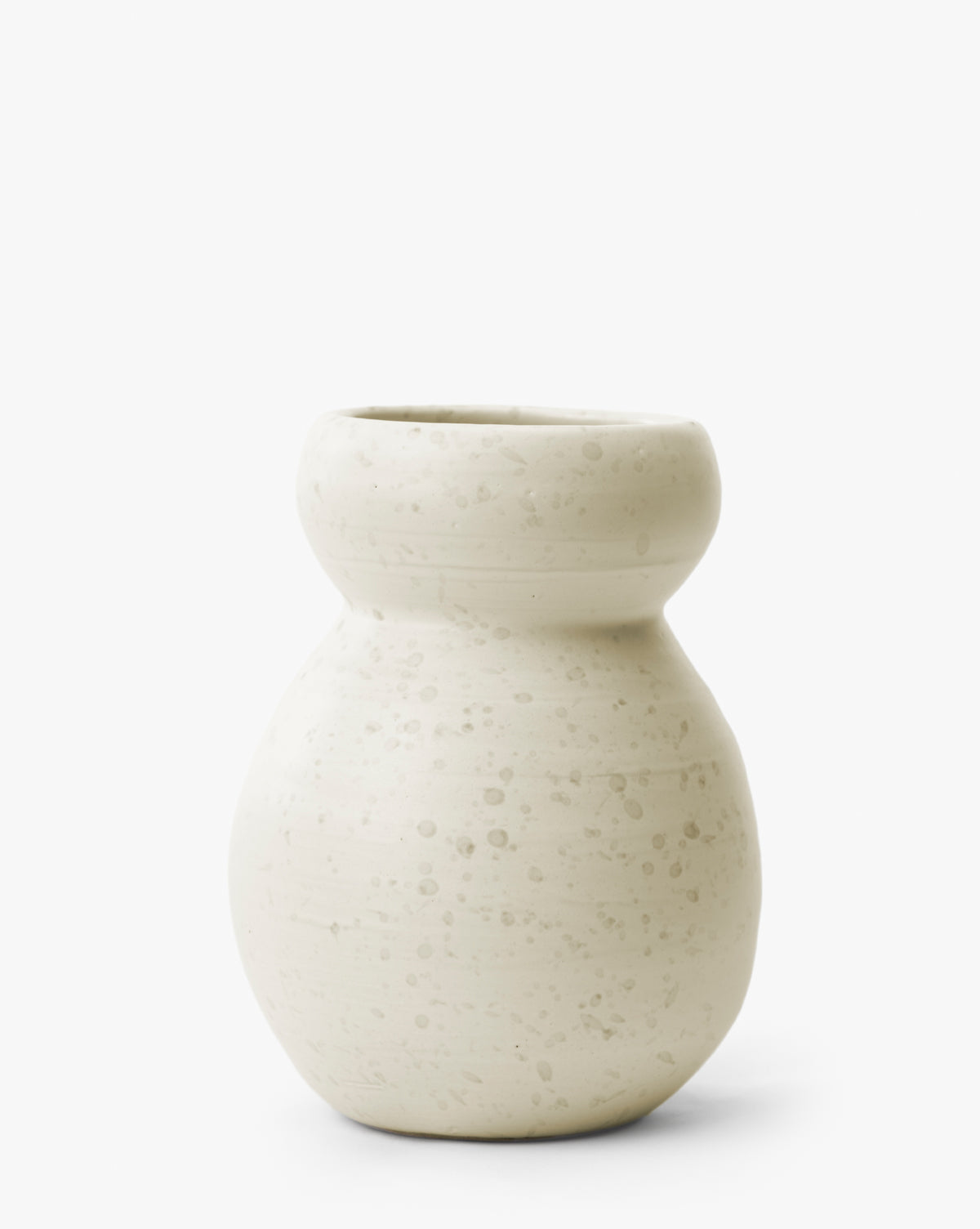 The Lyra Vase is a modern white ceramic vase with a round base, narrow neck, and wide rim, featuring a speckled off-white matte finish on a plain white background, by McGee & Co.