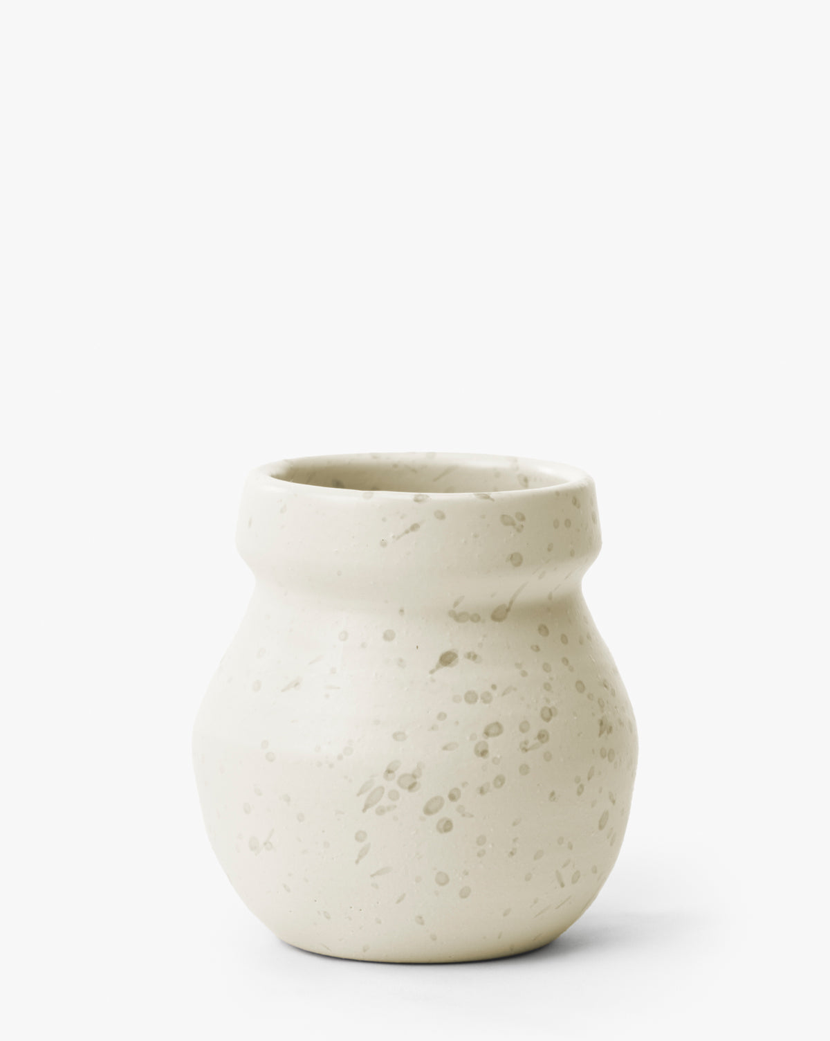 The Lyra Vase is a small, modern white ceramic vase with a wide neck and narrow base, featuring light beige tones and subtle speckled patterns, by McGee & Co.