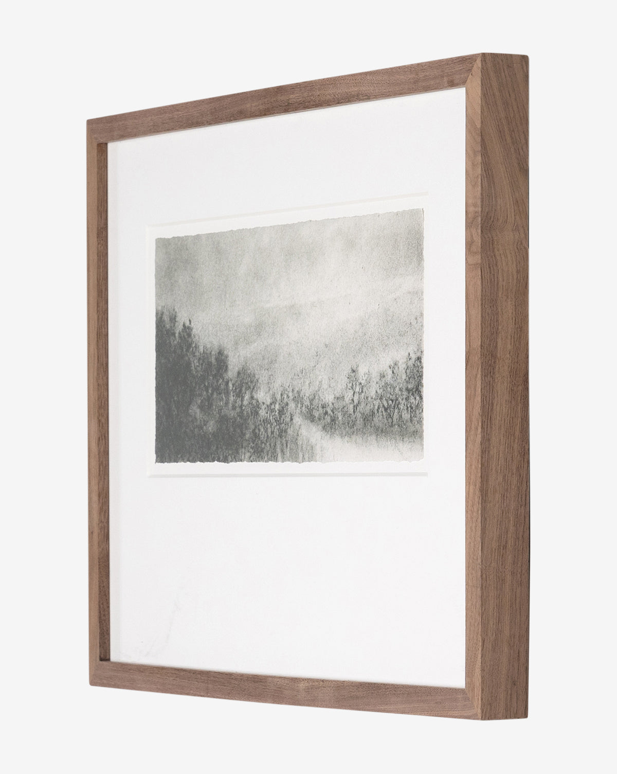 Hill Country Study I by Aileen Fitzgerald is a museum-quality charcoal drawing of a misty forest, displayed in a wooden frame with a white mat on a white background.