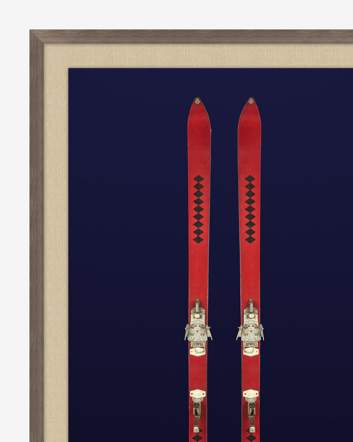 Antique Navy Skis II: Giclee print of vintage red skis with black diamond patterns on a dark blue background, elegantly framed in sleek walnut woodgrain.
