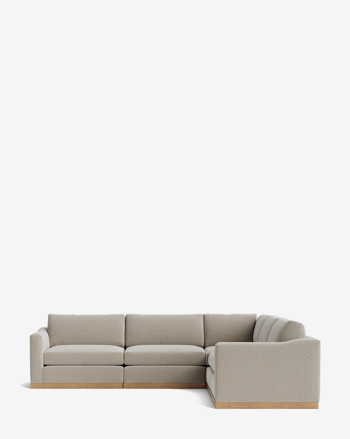 The Community Vernon Modular L Sectional 117.5 features light gray upholstery and a wooden base, offering customizable comfort and modern style, shown here against a plain white background. McGee & Co.