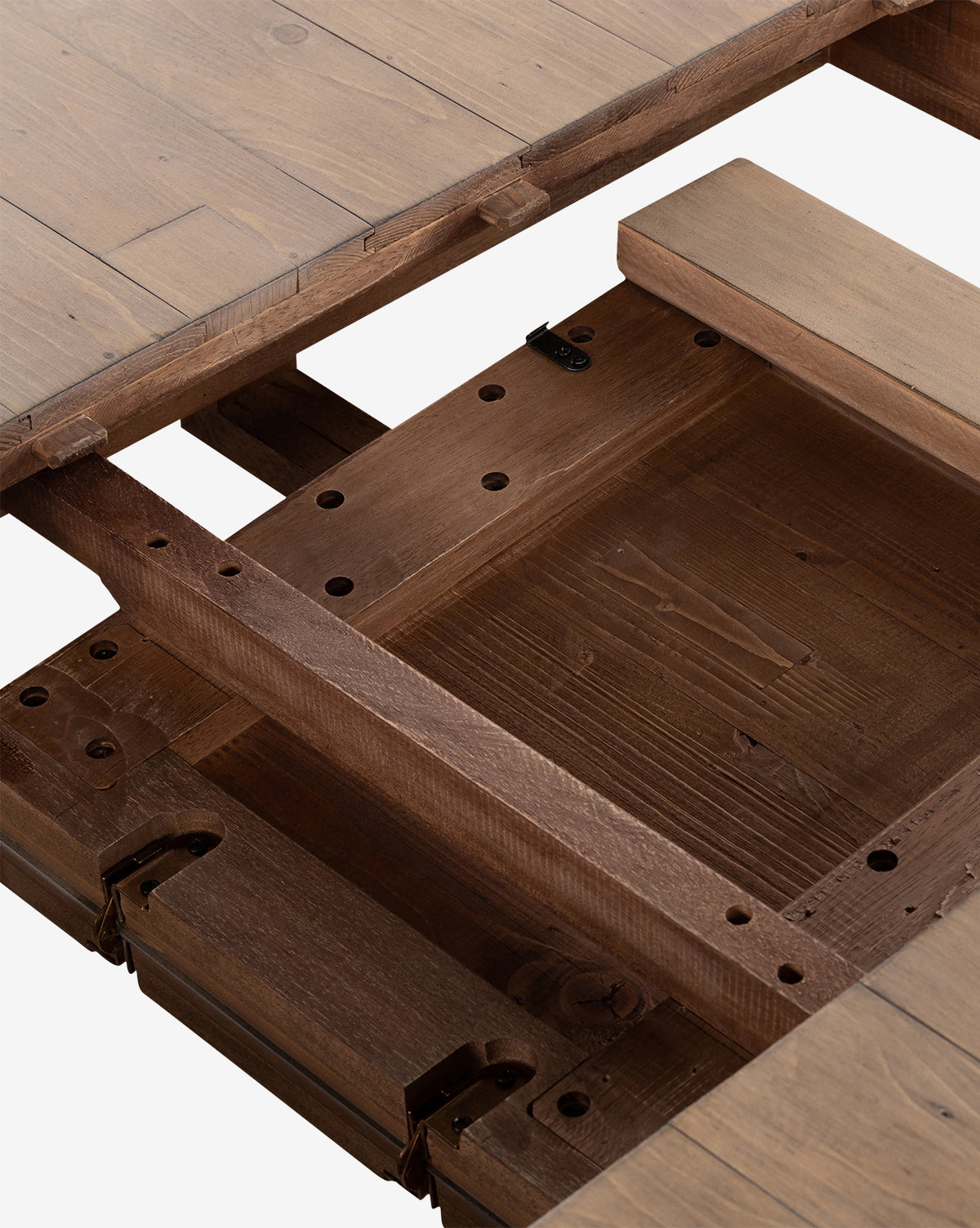 Close-up of the Elisha Extension Dining Table with its top separated, showing the butterfly leaf mechanism and support beams. The table features a natural wood finish with visible grain patterns, by McGee & Co.